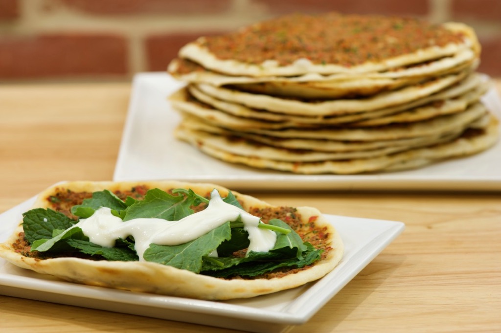 lahme b'ajeen with homemade yogurt, fresh mint, and baby kale